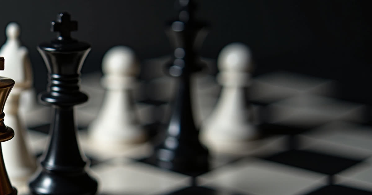 Black and white chess pieces arranged on a board